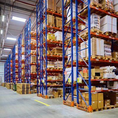Huge distribution warehouse with high shelves and loaders